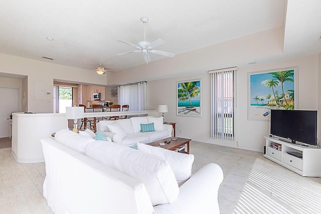 living room featuring ceiling fan and light hardwood / wood-style flooring