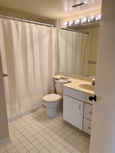 bathroom with a shower with shower curtain, tile patterned flooring, toilet, and vanity