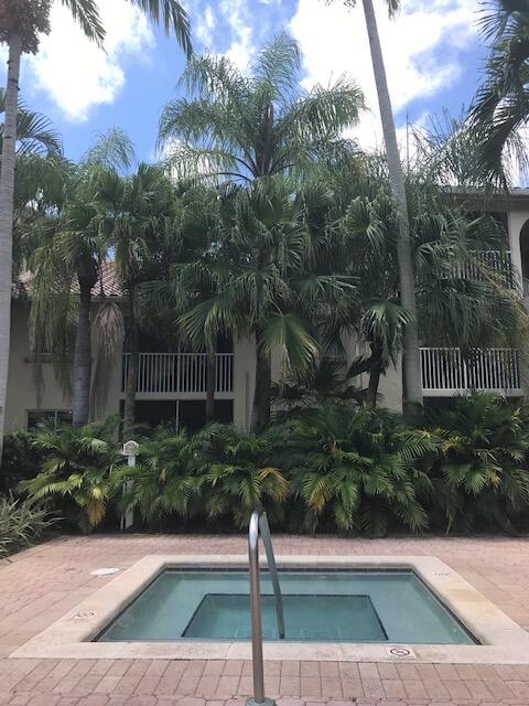 view of swimming pool with a hot tub