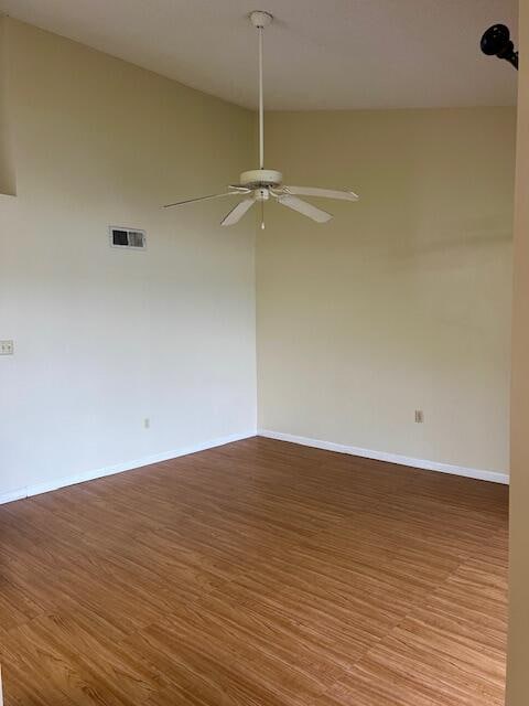 empty room with ceiling fan and hardwood / wood-style flooring