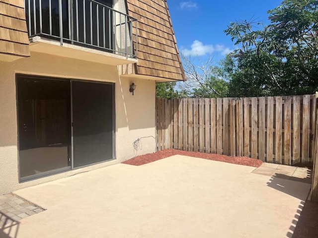 view of patio featuring a balcony