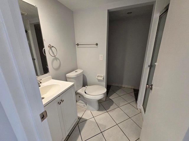 bathroom featuring tile patterned floors, walk in shower, vanity, and toilet