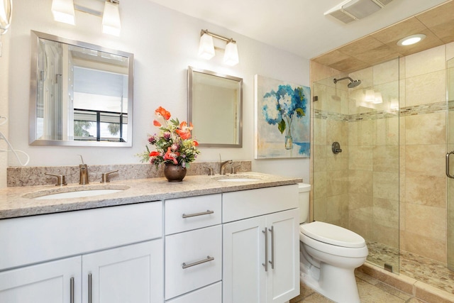 bathroom with vanity, toilet, and an enclosed shower