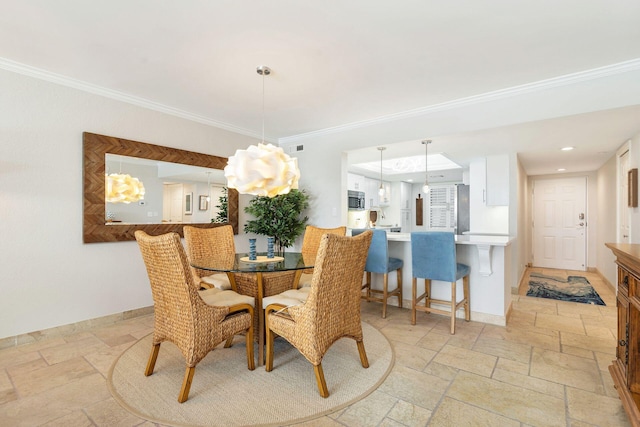 dining space with ornamental molding