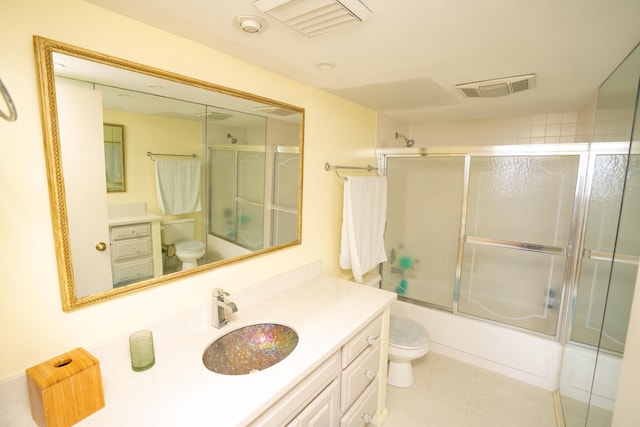 full bathroom with vanity, toilet, tile patterned floors, and combined bath / shower with glass door