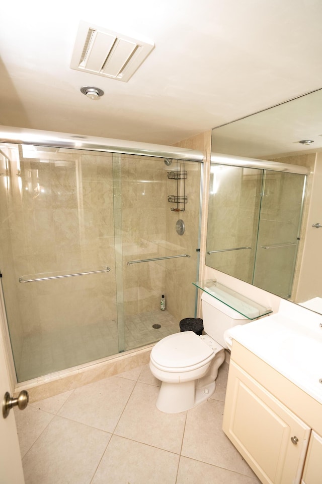 5200 N Flagler Dr Unit 803, West Palm Beach, FL 33407 - bathroom with a shower stall, tile patterned floors, toilet, and vanity
