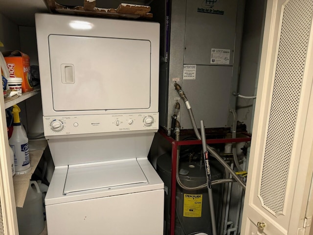 clothes washing area featuring stacked washing maching and dryer