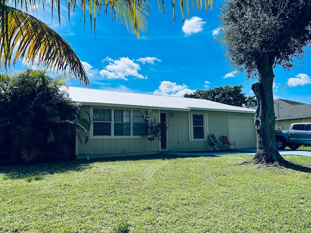 single story home with a front yard and a garage