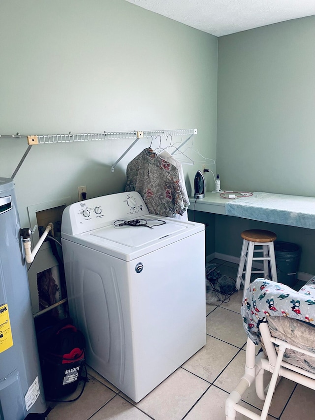 laundry area featuring washer / clothes dryer, light tile flooring, and electric water heater