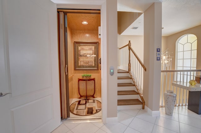 stairs featuring light tile floors