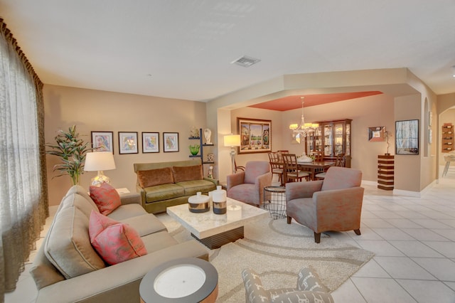 living room featuring a chandelier and light tile flooring