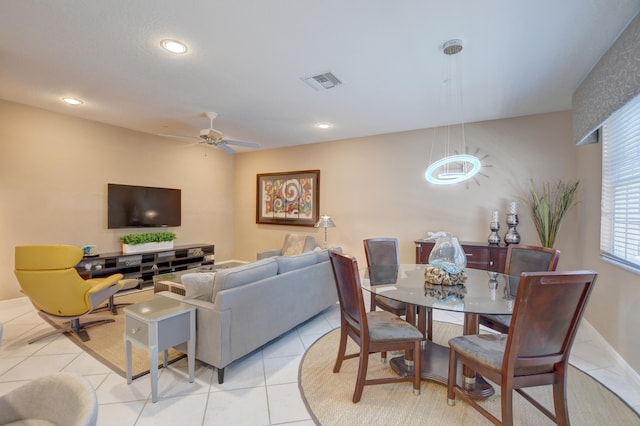 tiled dining space with ceiling fan