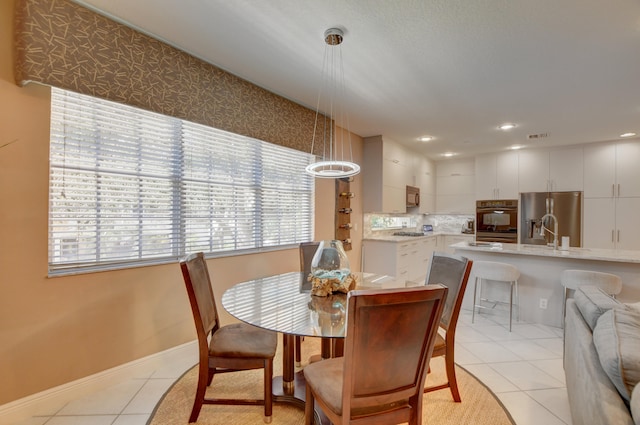 dining space with light tile flooring and sink