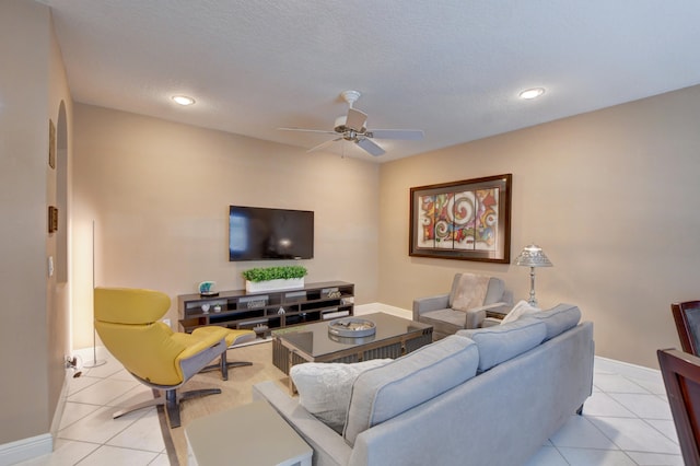 tiled living room featuring a textured ceiling and ceiling fan