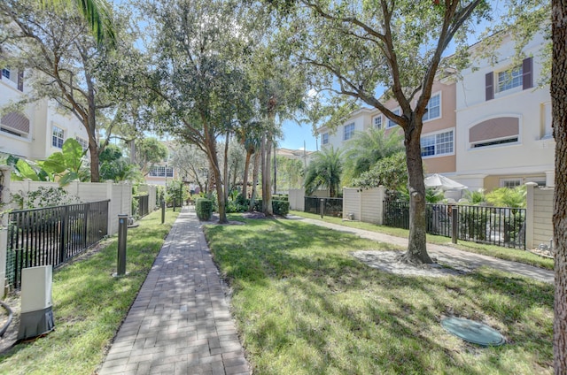 view of property's community with a lawn