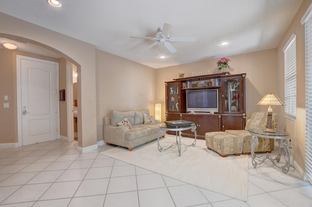 living room with light tile floors and ceiling fan