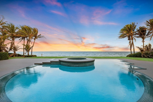 pool at dusk with a water view