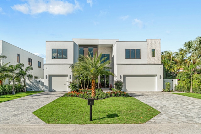 contemporary house with a front yard and a garage