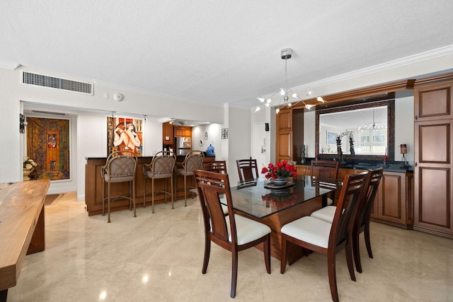 dining area featuring light tile floors, a textured ceiling, a chandelier, and crown molding