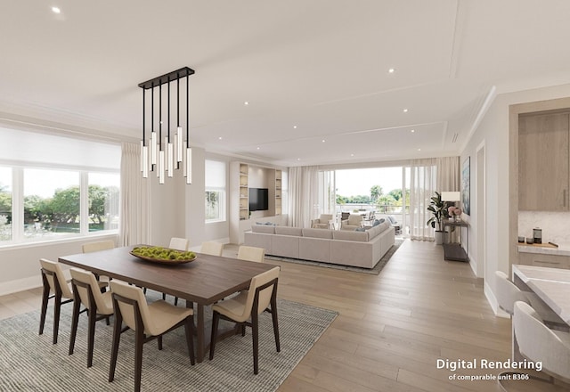 dining area with ornamental molding and light hardwood / wood-style flooring