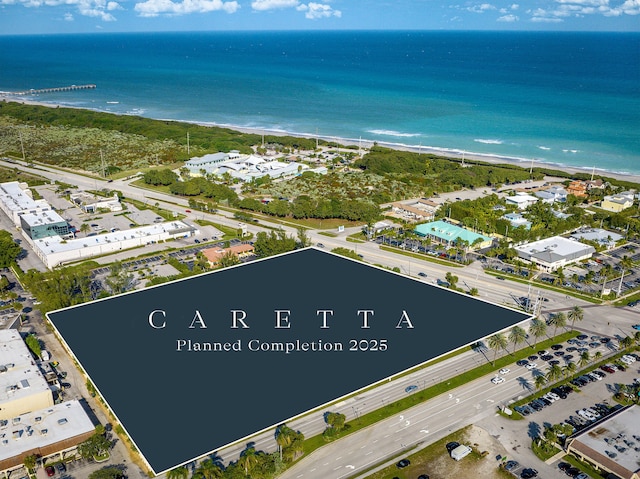 bird's eye view featuring a water view and a view of the beach