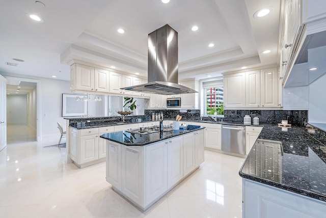 kitchen with stainless steel appliances, light tile flooring, island range hood, white cabinetry, and a center island