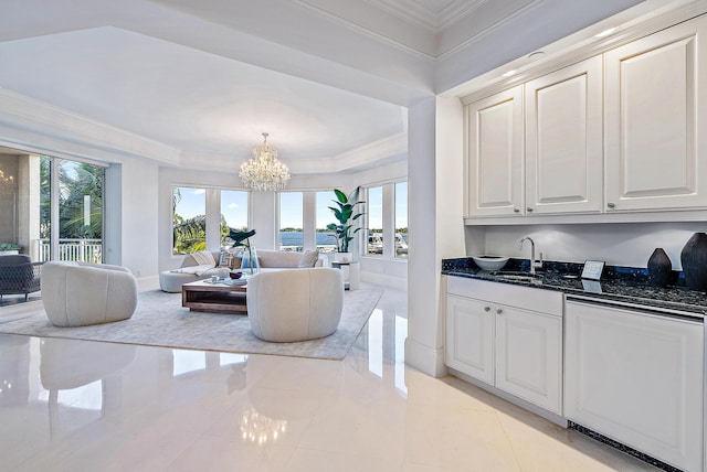 kitchen featuring decorative light fixtures, a notable chandelier, light tile flooring, dark stone counters, and white cabinetry