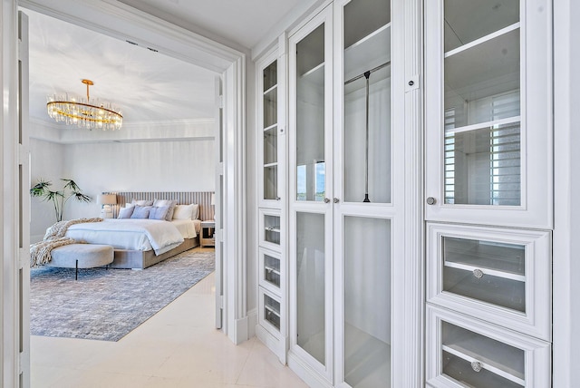 bedroom featuring an inviting chandelier and light tile floors