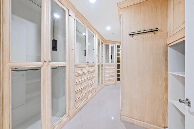 walk in closet featuring light tile floors