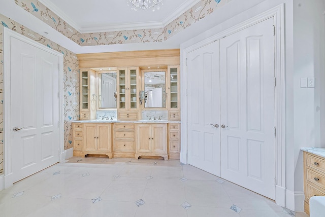 bathroom with an inviting chandelier, vanity, tile floors, and ornamental molding