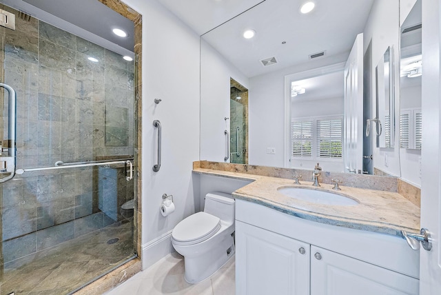 bathroom with an enclosed shower, tile flooring, vanity with extensive cabinet space, and toilet