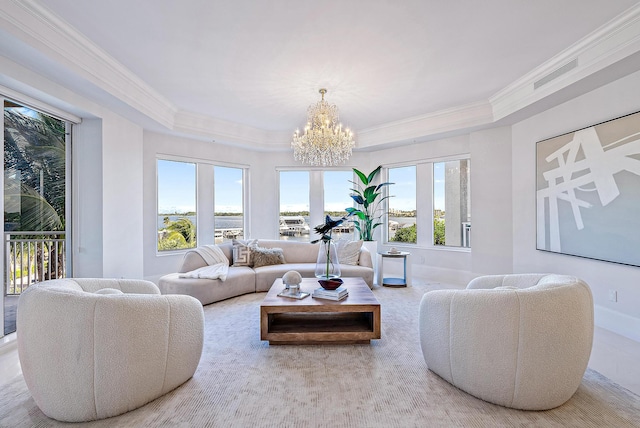 living room featuring a notable chandelier, plenty of natural light, and crown molding