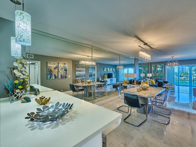 dining area with light tile flooring and a chandelier