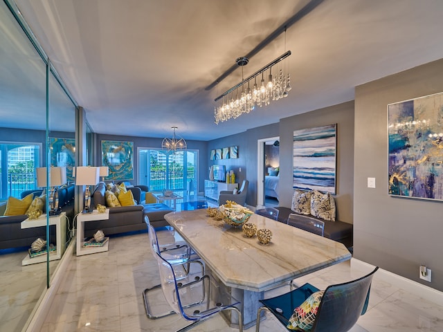 dining room with a notable chandelier, a healthy amount of sunlight, and light tile flooring