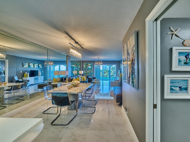 tiled dining room featuring an inviting chandelier