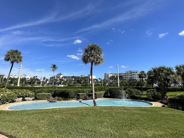 view of swimming pool featuring a yard