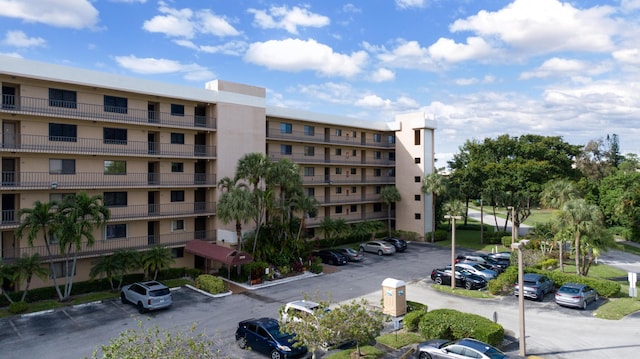 view of building exterior with uncovered parking