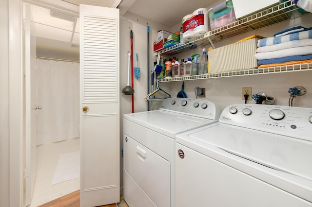 washroom with independent washer and dryer and laundry area