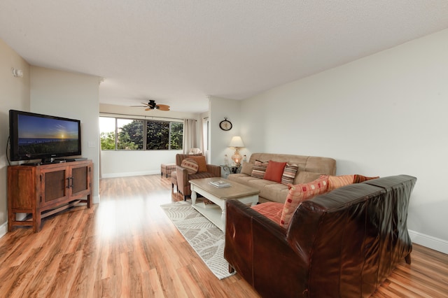 living room with ceiling fan and wood-type flooring