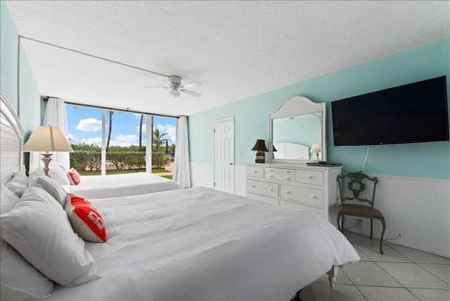 tiled bedroom with ceiling fan