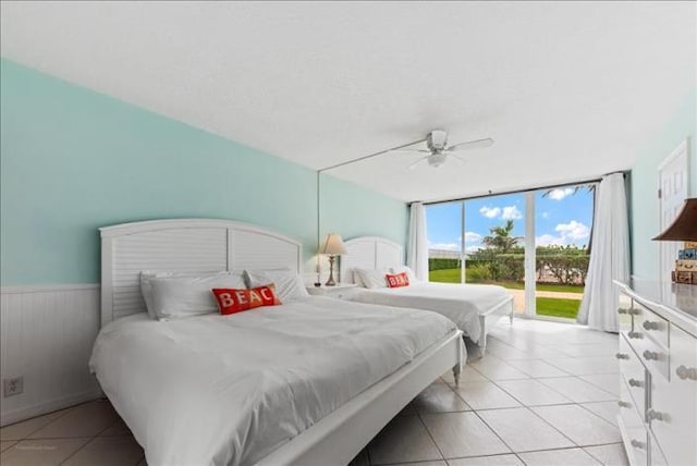 bedroom featuring light tile floors, ceiling fan, and access to outside