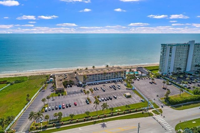 birds eye view of property featuring a water view and a view of the beach