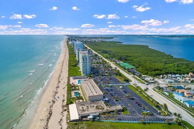 drone / aerial view featuring a beach view and a water view