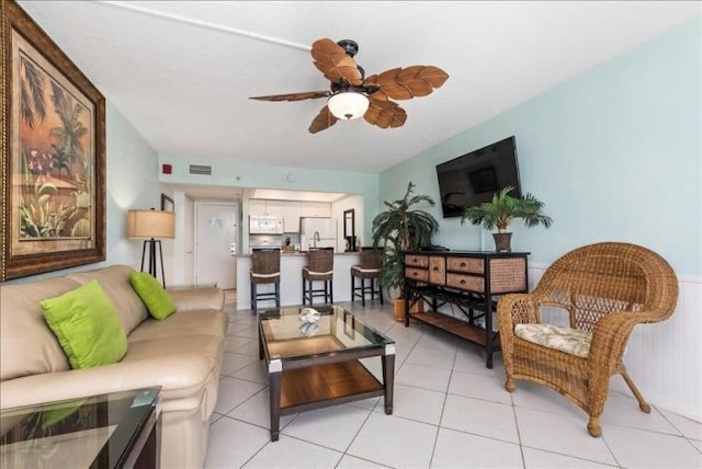 tiled living room featuring ceiling fan