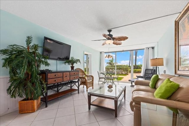 living room with ceiling fan and light tile flooring