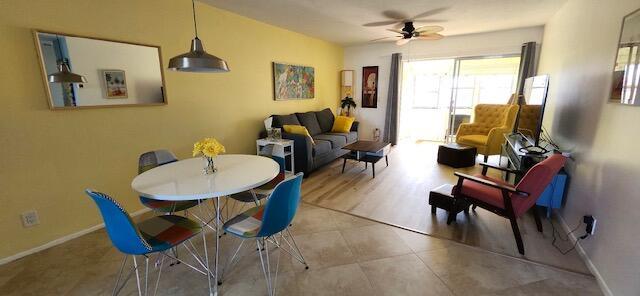 dining space featuring light wood-type flooring and ceiling fan