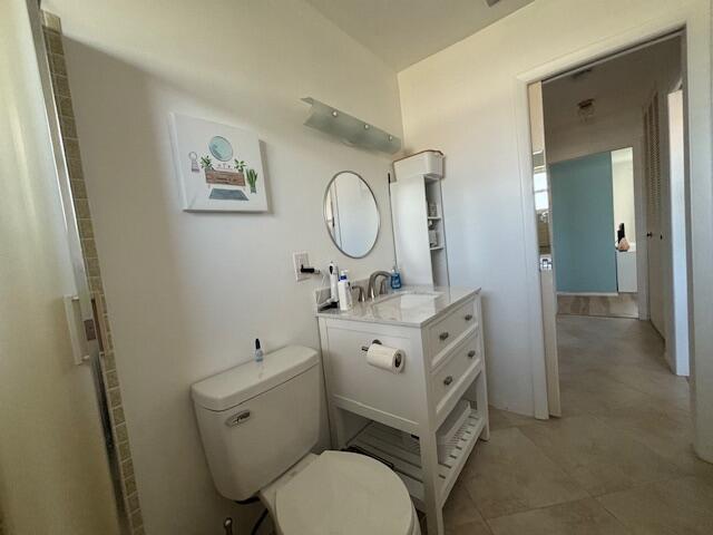 bathroom with vanity, toilet, and walk in shower