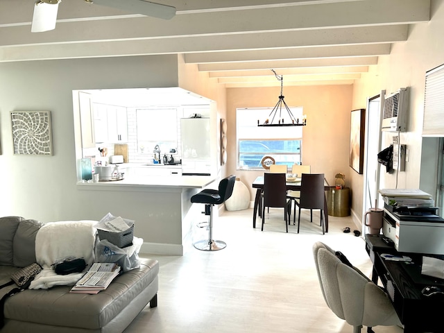 interior space featuring beamed ceiling and an inviting chandelier