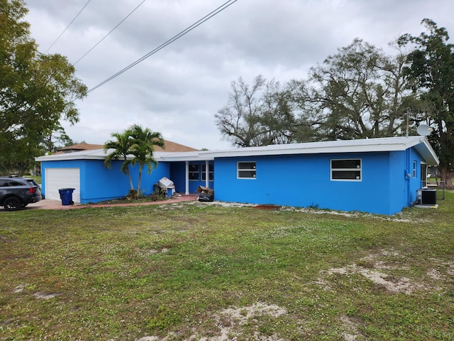 view of front facade with central air condition unit and a front yard