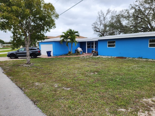 single story home featuring a front yard and a garage